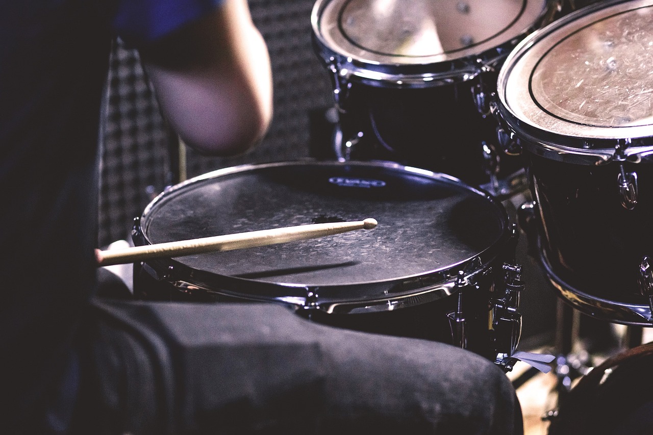 a close up of a person playing drums, a picture, by Matt Cavotta, shutterstock, cinematic detail, photorealistic shot, band playing instruments, full image