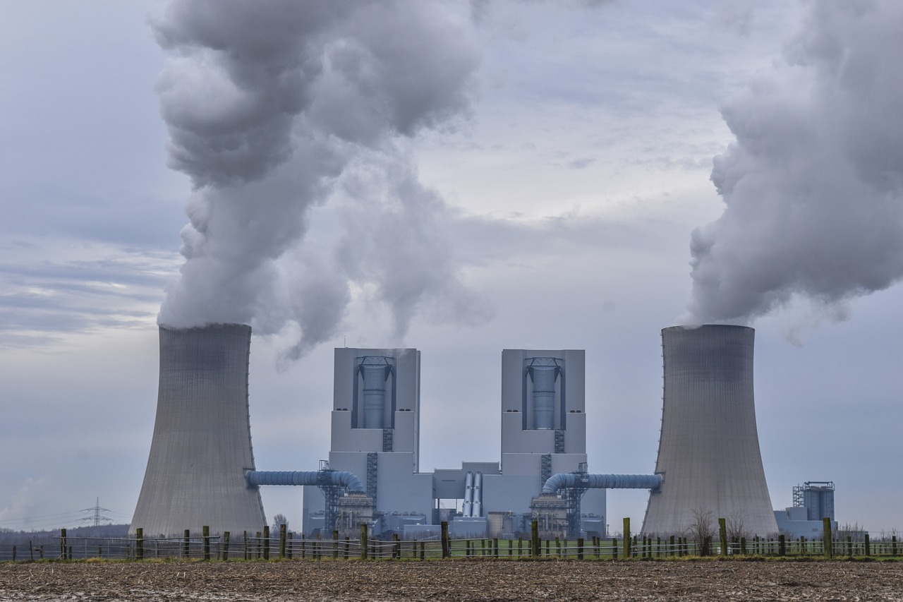 a couple of cooling towers with smoke coming out of them, a picture, by Werner Gutzeit, pexels, pillars, where a large, shodan, grey