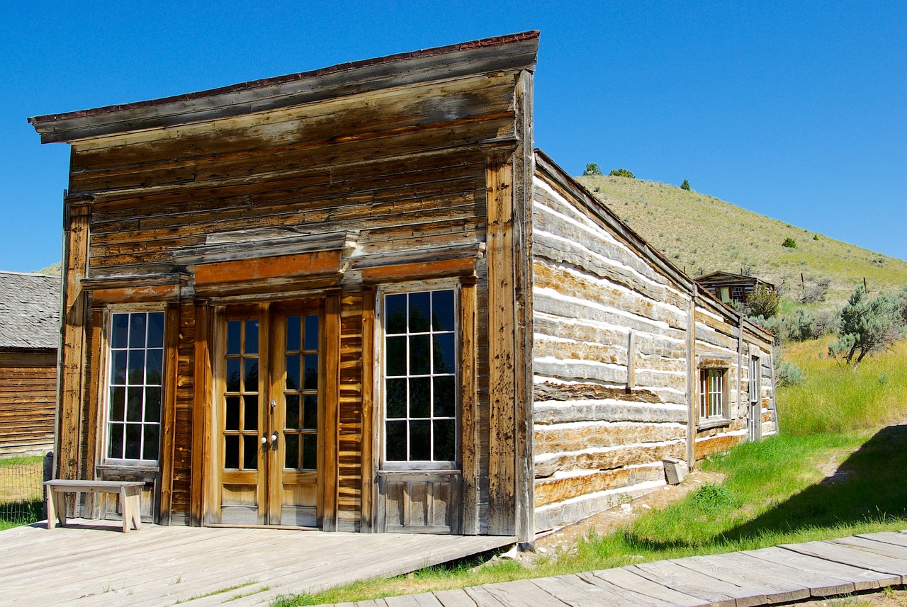 a small wooden building sitting on the side of a road, by Joseph Yoakum, shutterstock, renaissance, montana, outside a saloon, 1820, log houses built on hills