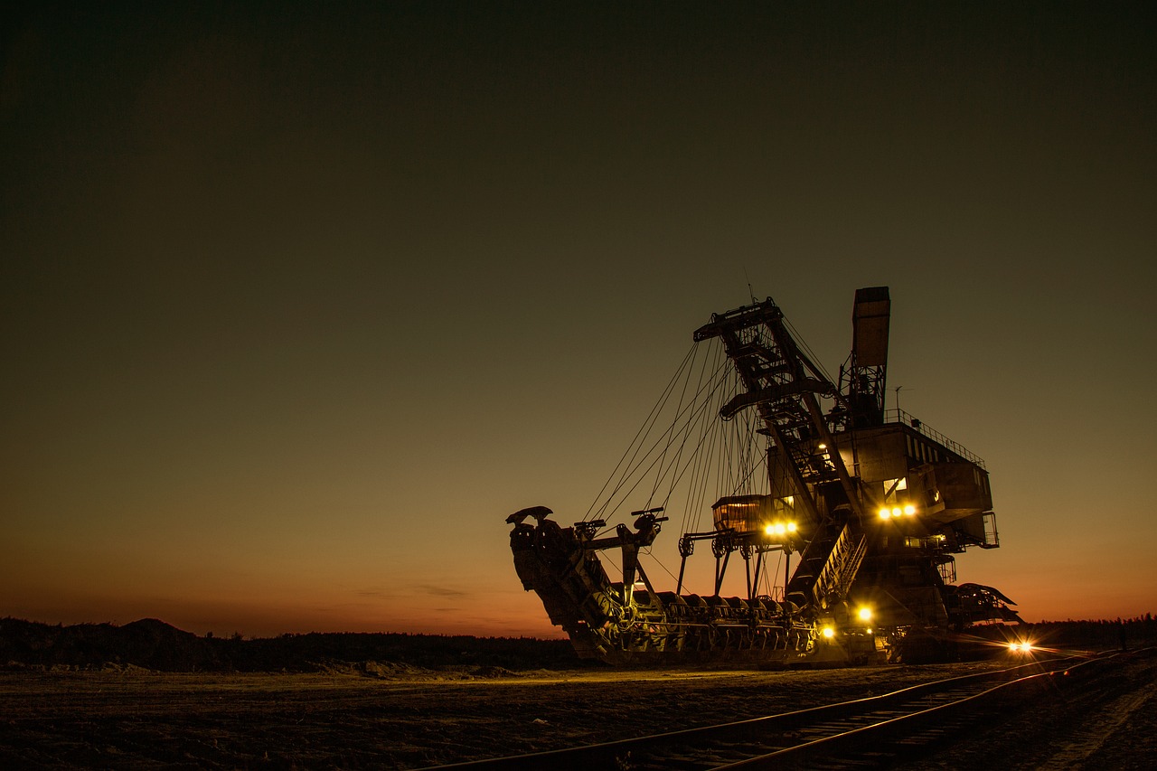 a large crane sitting on top of a train track, a stock photo, by Thomas Häfner, pexels contest winner, moody mining planet, at twilight, big shovel, highly detailed product photo