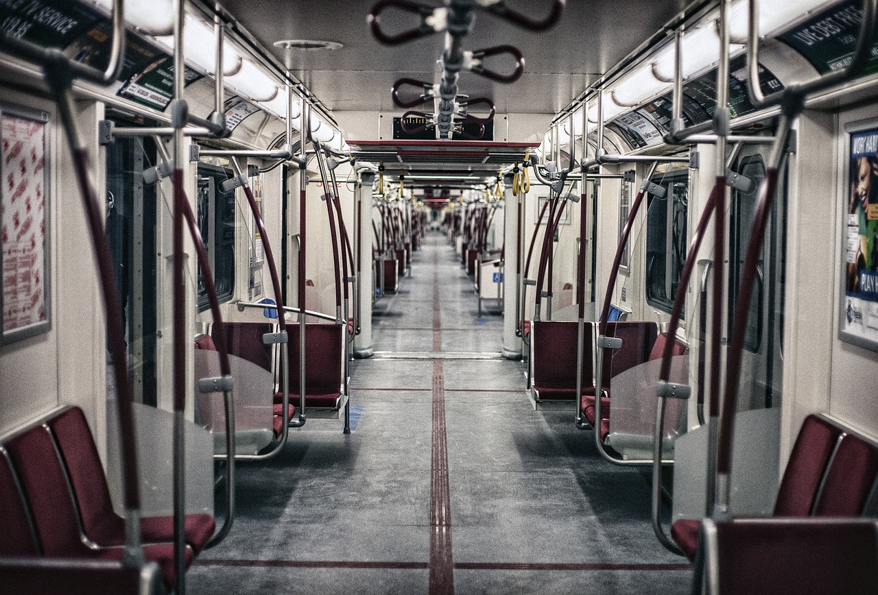 the inside of a subway car with red seats, by Raymond Normand, unsplash contest winner, toronto, dystopian feel, train with maroon, in the middle of the city