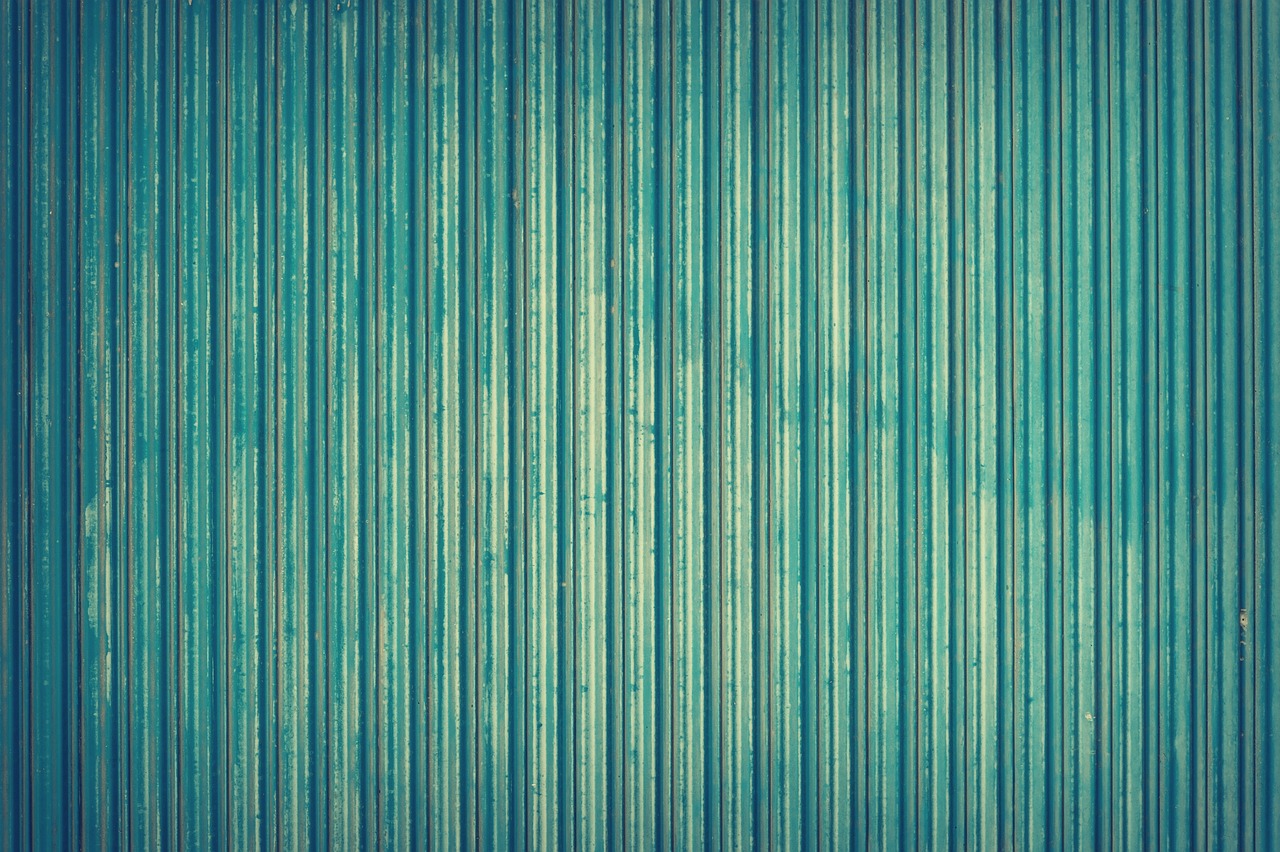 a close up of a blue corrugated wall, a stock photo, inspired by Elsa Bleda, vintage retro colors, top - down photograph, bamboo, greenish colors