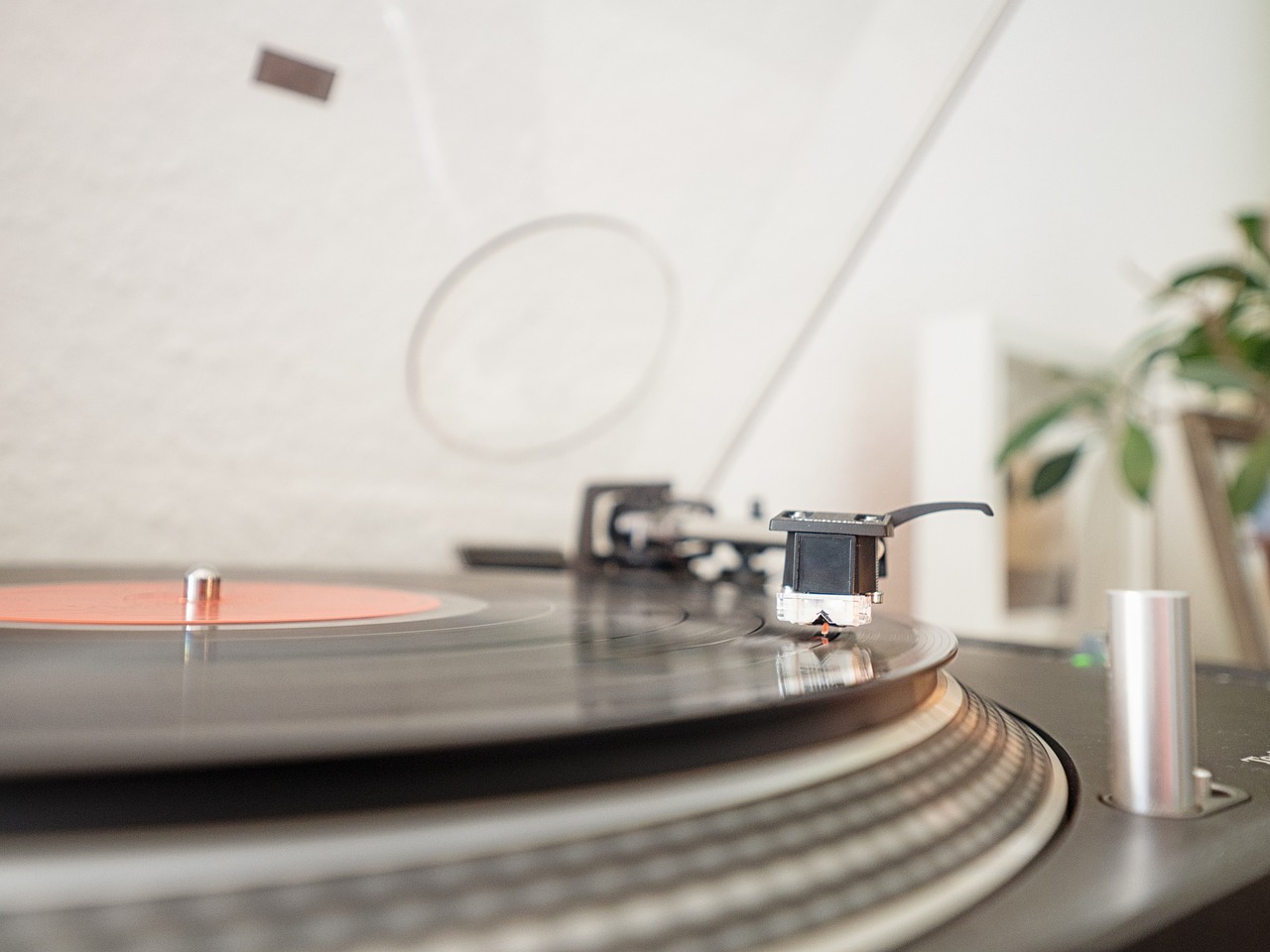 a record player sitting on top of a turntable, a picture, by Ottó Baditz, shutterstock, clear focused details, indoor shot, ar 16:9, cable plugged in