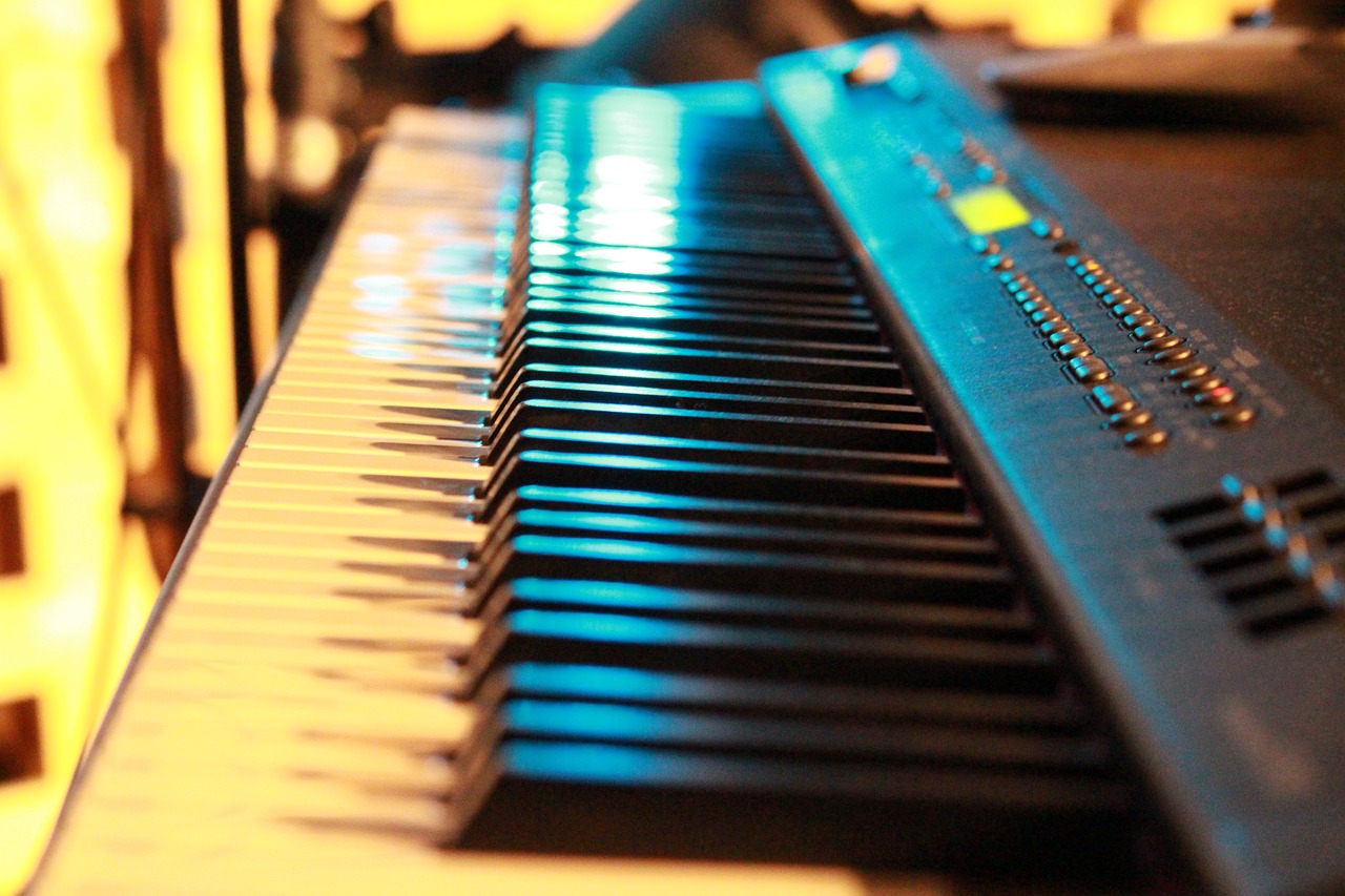 a close up of a keyboard on a table, a picture, by Matt Cavotta, bright glowing instruments, denoised, profile close-up view, file photo
