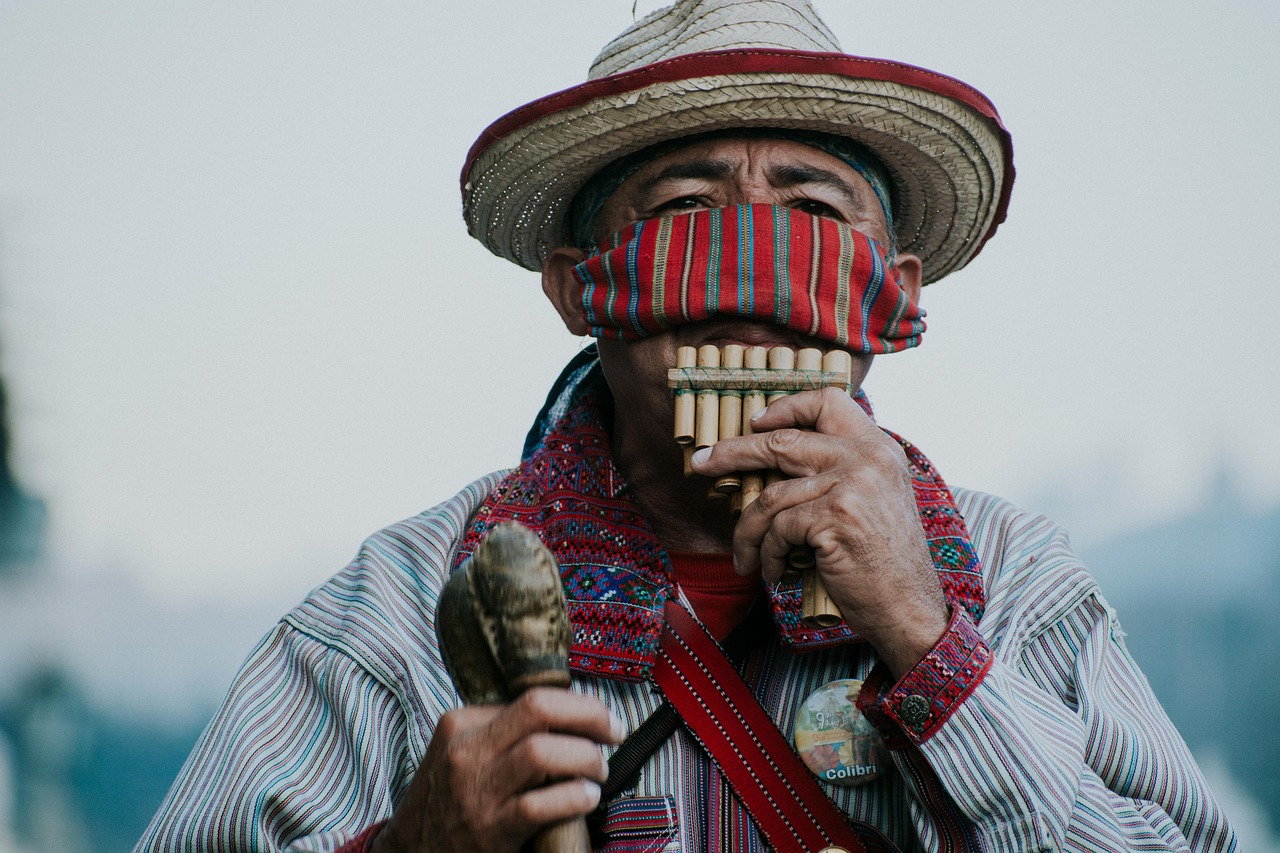 a man in a straw hat playing a flute, by Alejandro Obregón, pexels contest winner, tribal masks, poncho, unsplash photo contest winner, mime