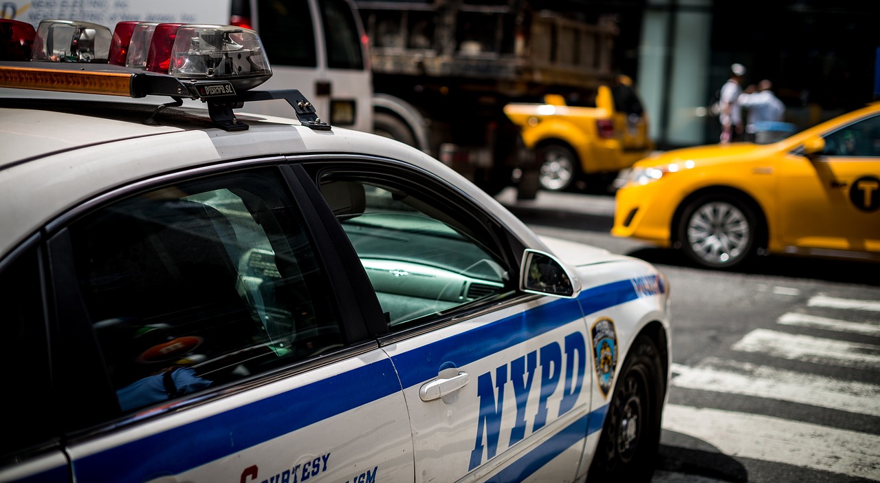 a close up of a police car on a city street, by Matt Stewart, new york city, 1 / 2 headshot, random content, very high resolution