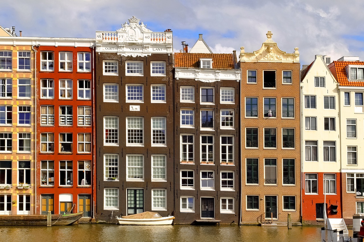 a row of buildings next to a body of water, by Emanuel de Witte, shutterstock, dutch style, stock photo