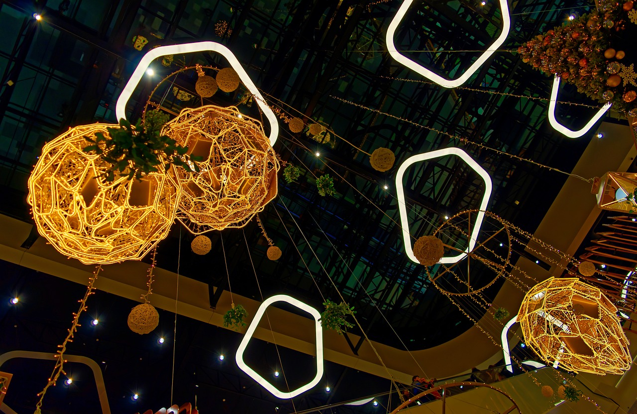 a bunch of lights hanging from the ceiling, flickr, interactive art, malls, golden shapes, rim lights and caustics, city lights made of lush trees