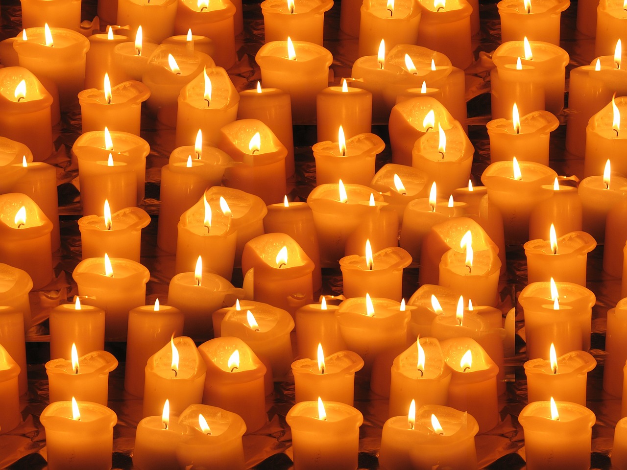 a group of lit candles sitting on top of a table, a picture, pexels, digitally enhanced, yellow lanterns, hundreds of them, craig wylie