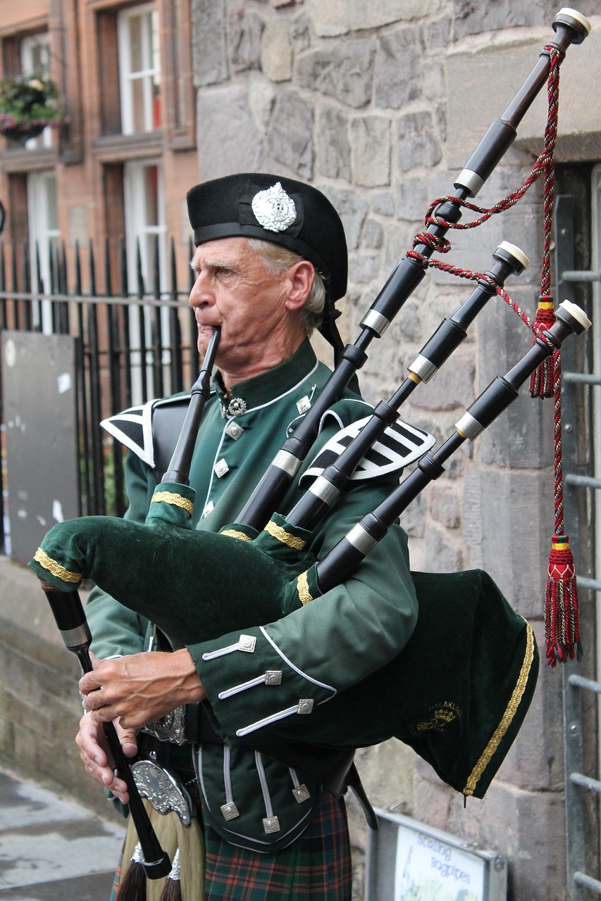 a man in a kilt playing a bagpipe, a photo, by John Murdoch, pexels, wearing dark green robes, avatar image, finely detailed, in an urban setting