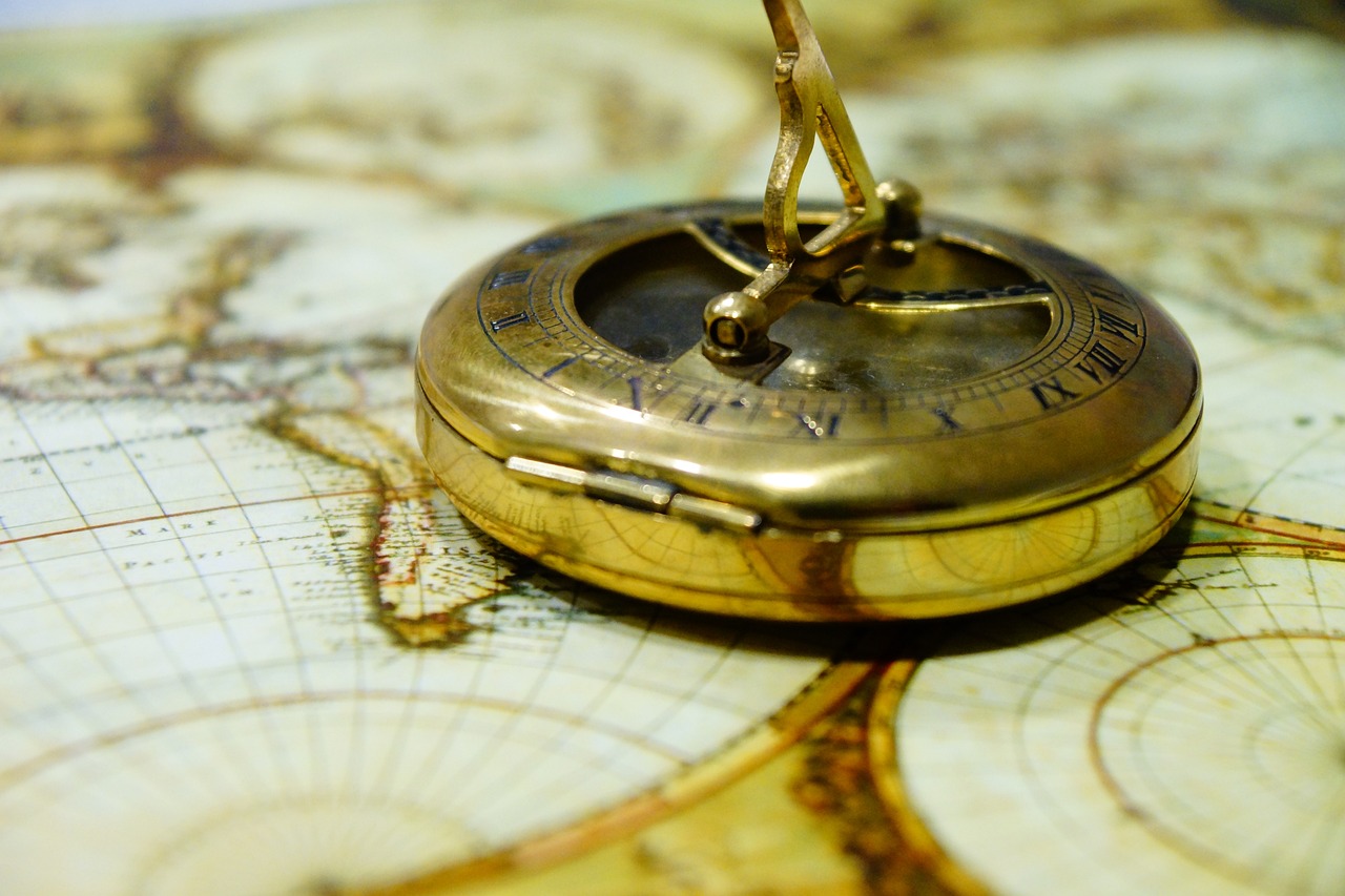 a gold compass sitting on top of a map, a photo, by Eugeniusz Zak, renaissance, wallpaper mobile, caught in the flow of time, bronze, intriciate detail