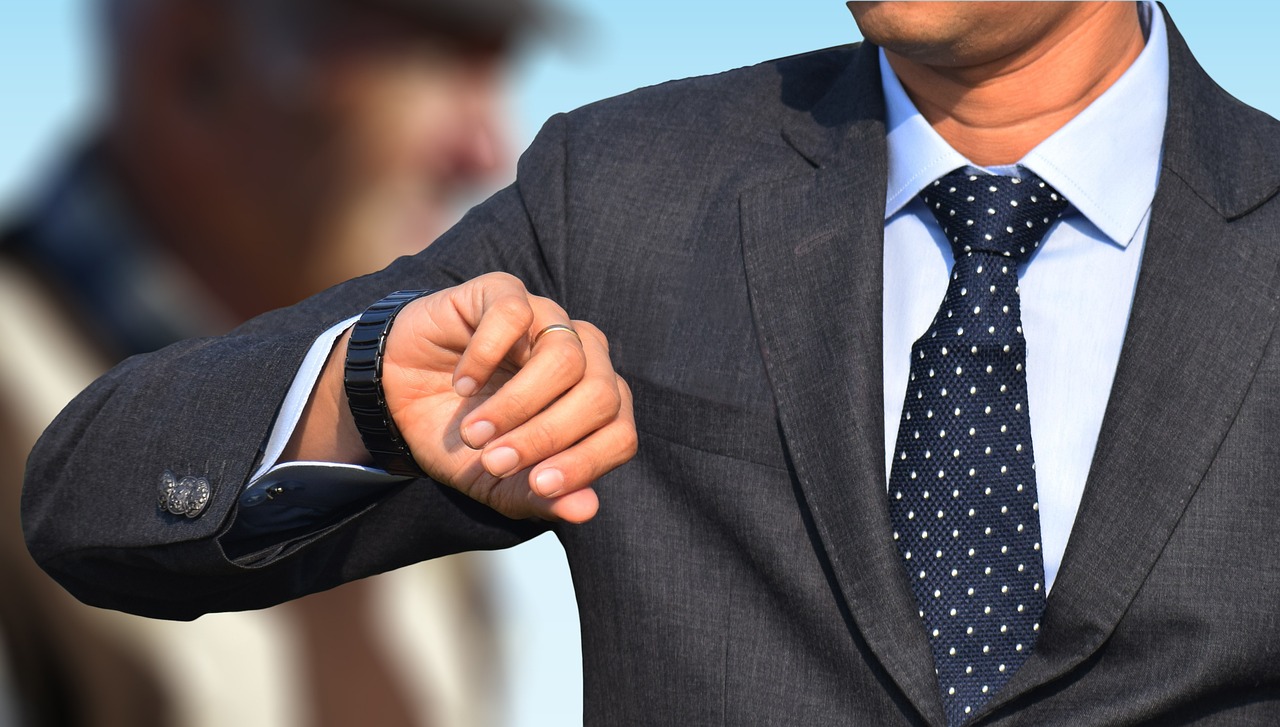 a close up of a person wearing a suit and tie, pixabay, wearing a watch, pointing, wearing track and field suit, fined detail