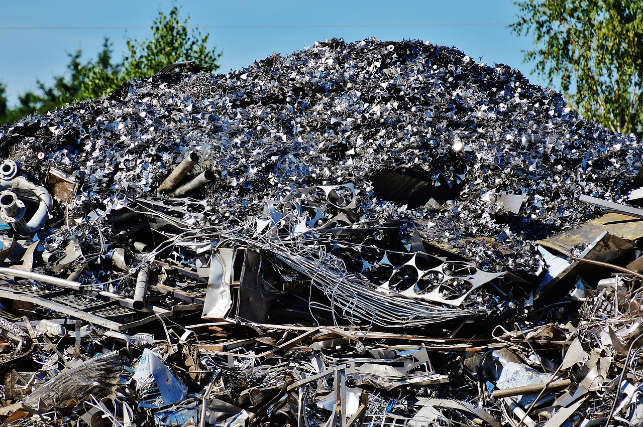 a pile of scrap metal sitting on top of a pile of trees, a photo, pixabay, plasticien, shiny skin”, ebay photo, illinois, grain”