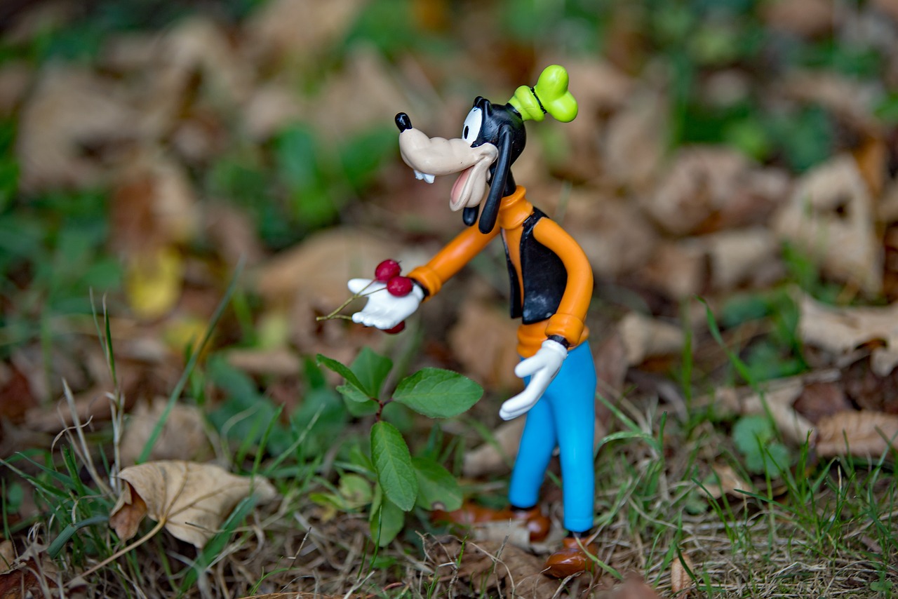 a figurine of goofy with a tennis ball in his hand, inspired by Tex Avery, flickr, figuration libre, in the autumn forest, dslr focus on the subjects, crash bandicoot, clover