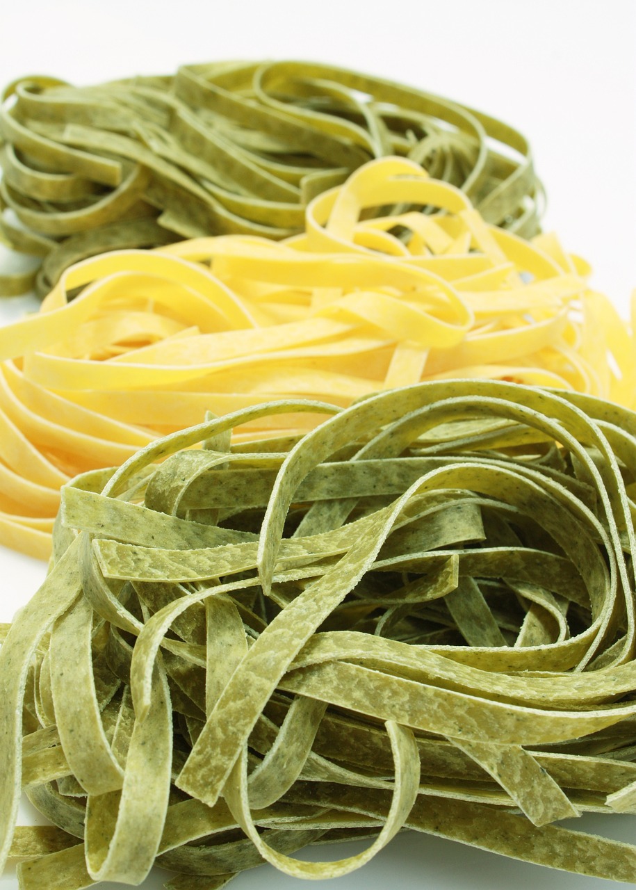 a pile of pasta sitting on top of a white table, a picture, shutterstock, green and yellow colors, green lines, morning detail, three colors