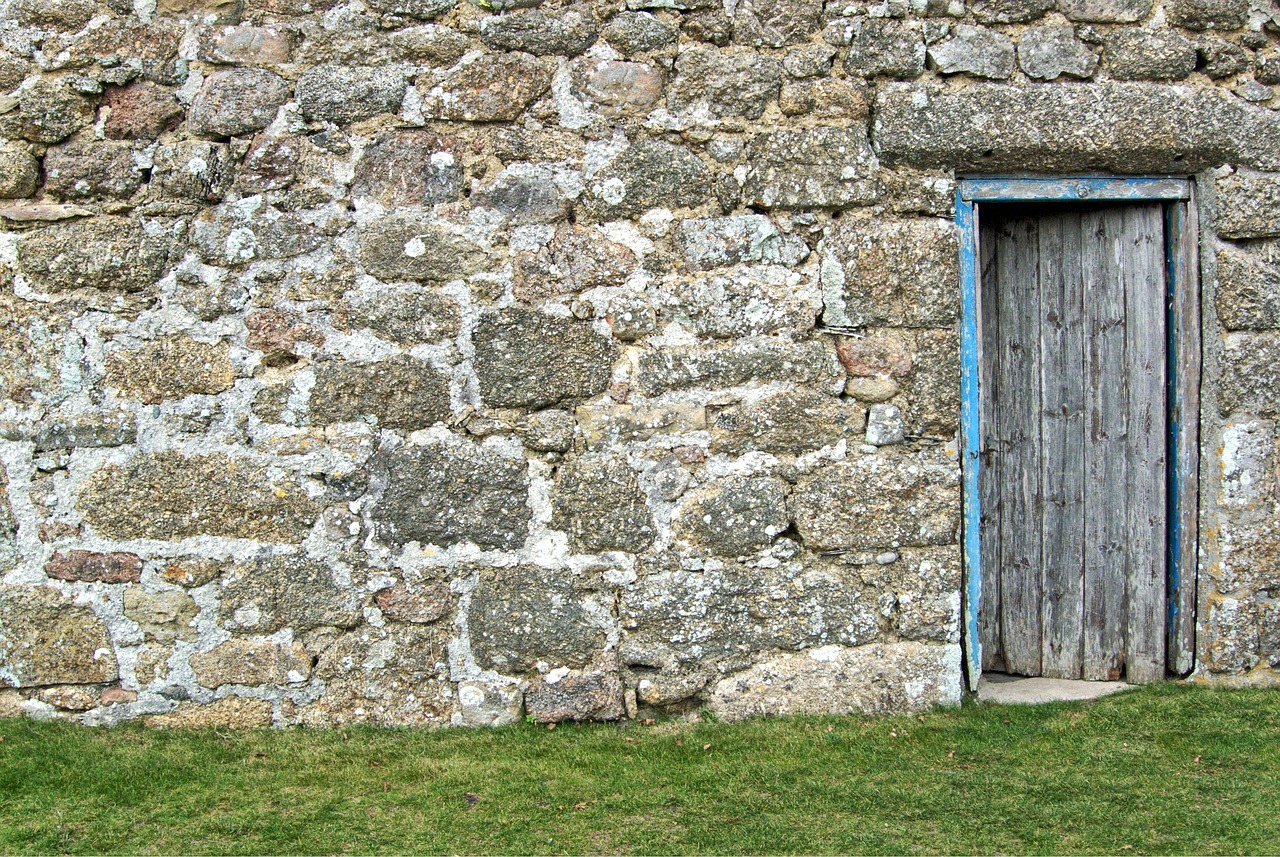 an old stone wall with a blue door, inspired by David Ramsay Hay, flickr, panoramic, hyper - detail, field, 1 7 th century