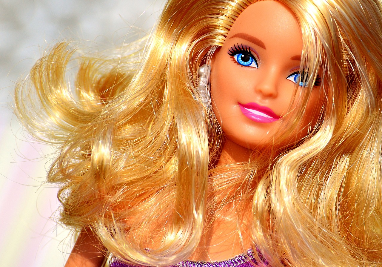 a close up of a barbie doll with blonde hair, a picture, by Tom Carapic, pixabay, toy commercial photo, flowing hair, she is smiling, leaked image