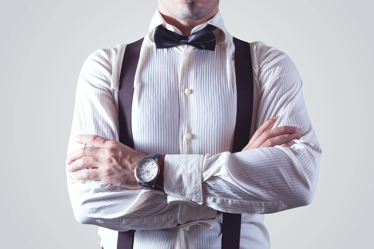 a man wearing a bow tie and suspenders, a photo, pristine and clean design, watch photo