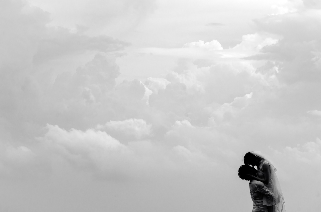 a black and white photo of a bride and groom, by Sudip Roy, unsplash, romanticism, clouds background, making love, panorama view of the sky, wallpaper - 1 0 2 4