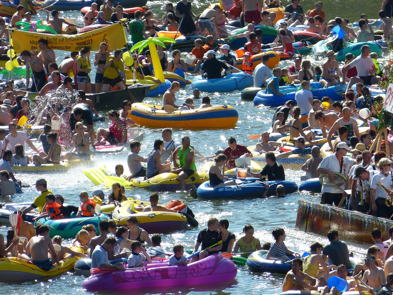 a large group of people floating on inflatable rafts, a photo, by Edward Corbett, peacefully drinking river water, carnival, marathon, watch photo