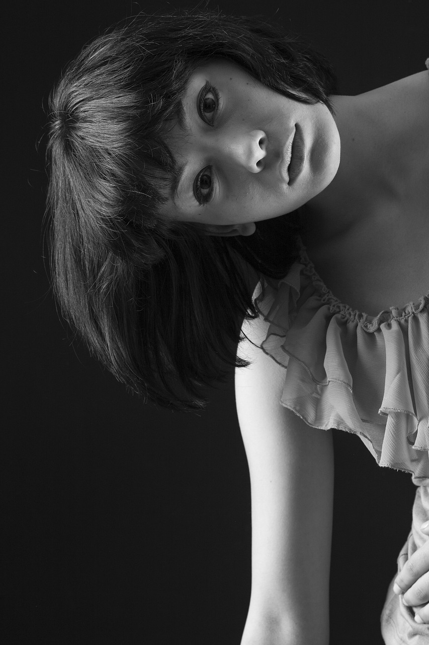 a black and white photo of a woman in a dress, a black and white photo, by Kiyohara Tama, close - up studio photo, soft volumetric studio lighting, of a youthful japanese girl, with a fringe