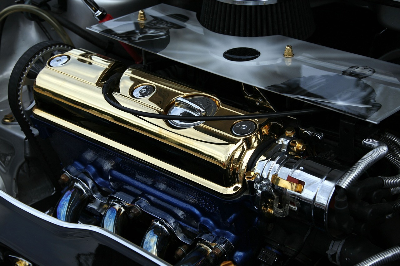 a close up of the engine of a car, draped in shiny gold and silver, colors with gold and dark blue, classic chrome, [ [ hyperrealistic ] ]