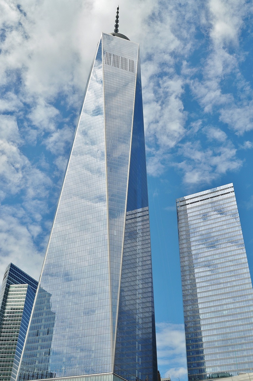 a couple of tall buildings sitting next to each other, a picture, by William Berra, pexels, modernism, world trade center twin towers, huge glass structure, cloud, usa-sep 20