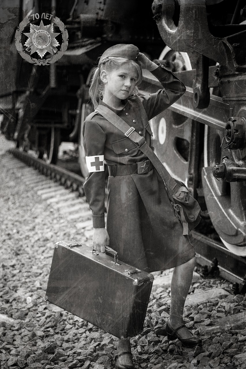 a black and white photo of a little girl standing next to a train, socialist realism, first aid kit, 🕹️ 😎 🔫 🤖 🚬, girl wearing uniform, by rainer hosch