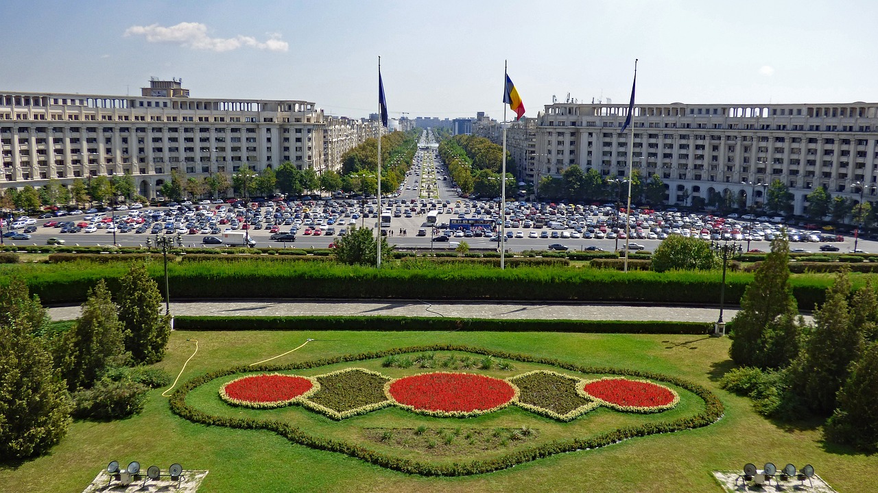 a large flower garden in front of a large building, a photo, by Alexander Fedosav, wikimedia commons, boulevard, cristi balanescu, helipad