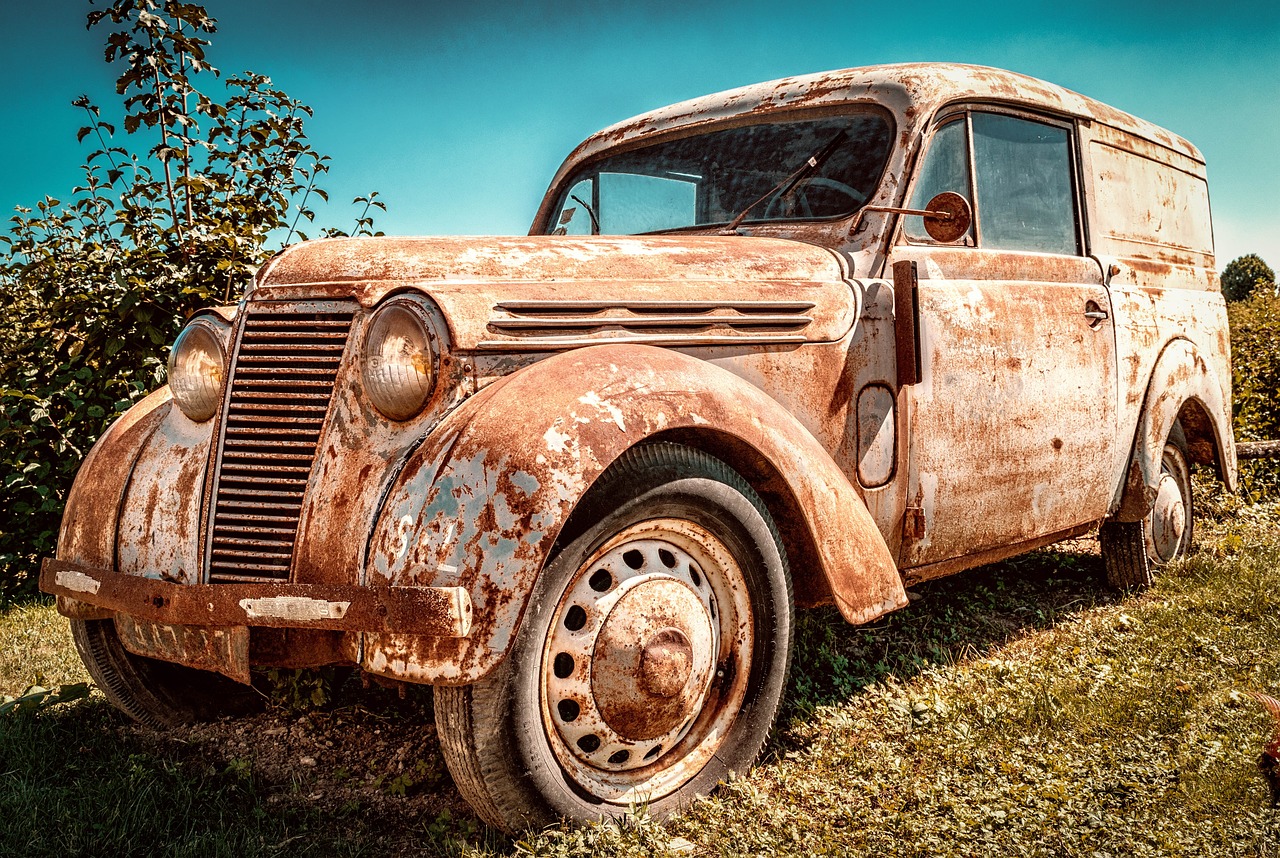 an old rusted car sitting in a field, by Erik Pevernagie, trending on pixabay, photorealism, stained antique copper car paint, finely detailed car, photorealism. trending on flickr, mechanic