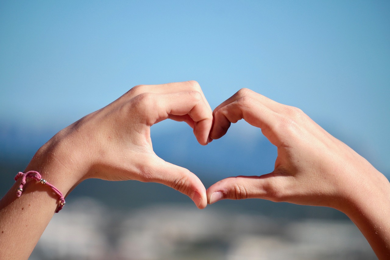 a person making a heart with their hands, shutterstock, nice view, advertising photo, closeup photo, stock photo