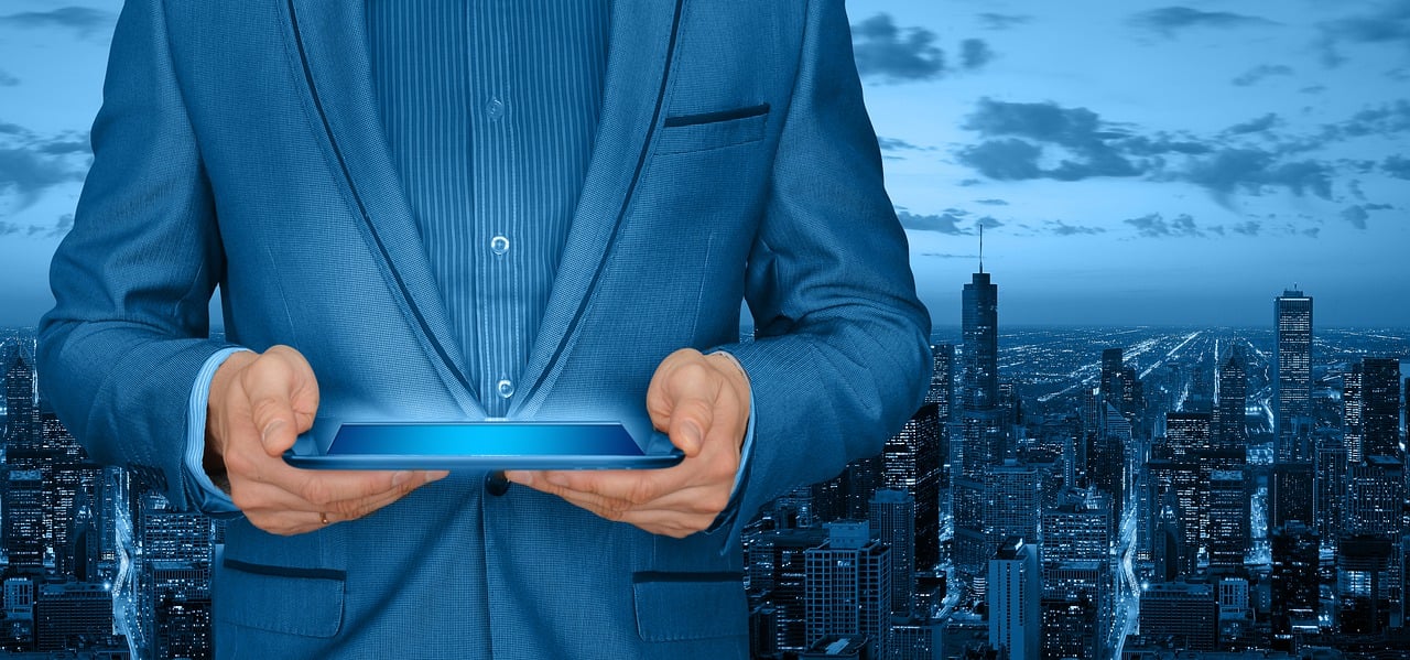 a man in a suit holding a tablet computer, a digital rendering, by Kurt Roesch, shutterstock, around the city, wearing blue jacket, closeup photo, istockphoto