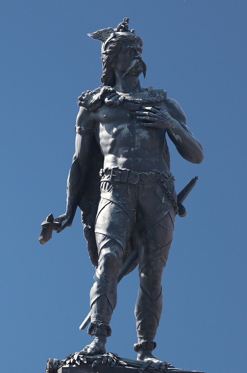 a statue of a man with a sword on top of a building, inspired by Pedro Álvarez Castelló, new sculpture, skilled warrior of the apache, wearing loincloth, very sparse detail, the man looked up