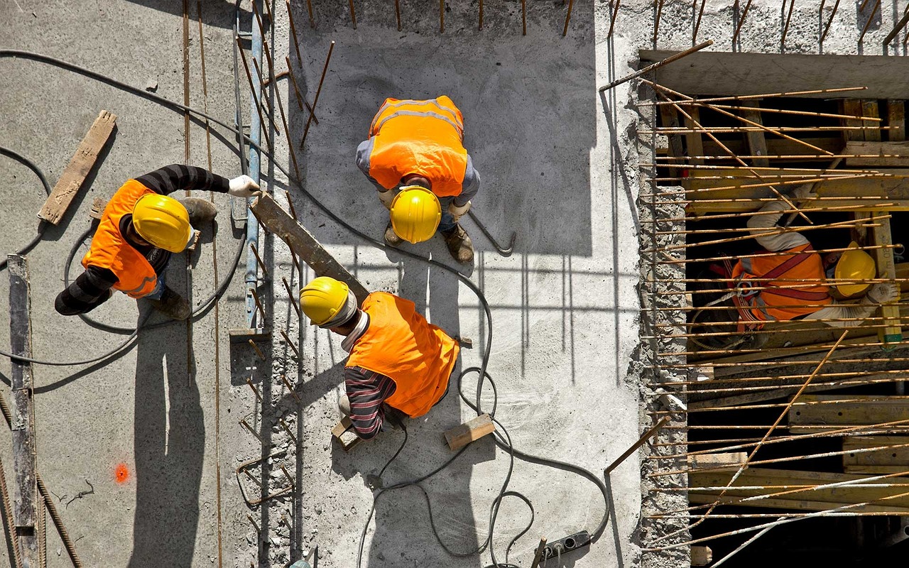 a group of construction workers working on a building, a photo, by John Murdoch, shutterstock, [ overhead view ]!!, concrete pillars, background image, wearing hi vis clothing