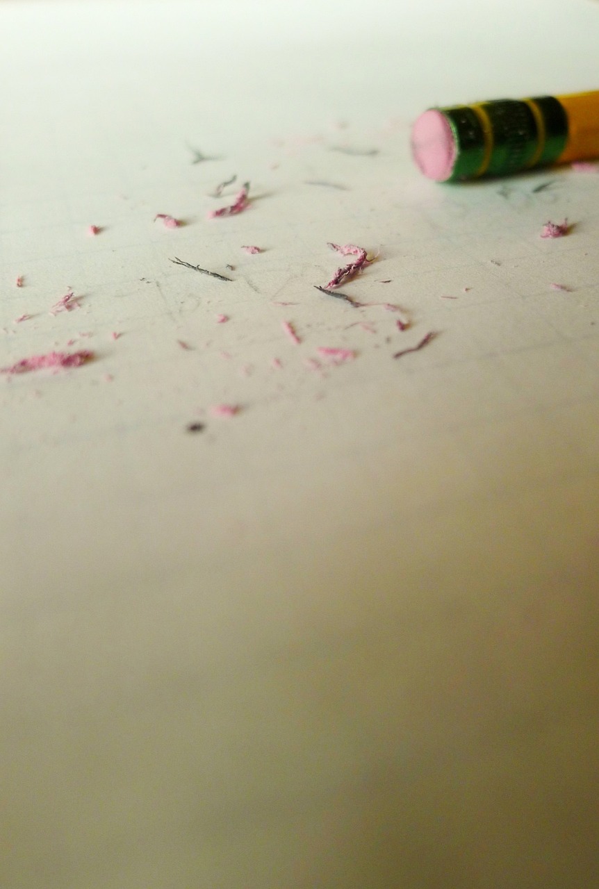 a pink crayon sitting on top of a white table, inspired by Cy Twombly, macro 8 mm, lying scattered across an empty, action shot, middle of the page