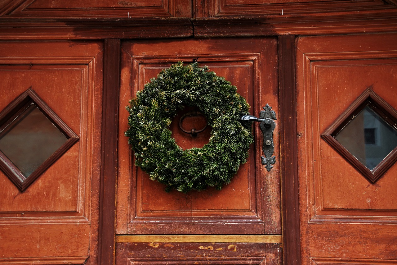 a close up of a door with a wreath on it, pexels, 16th century, manual, getty images, kreuzberg