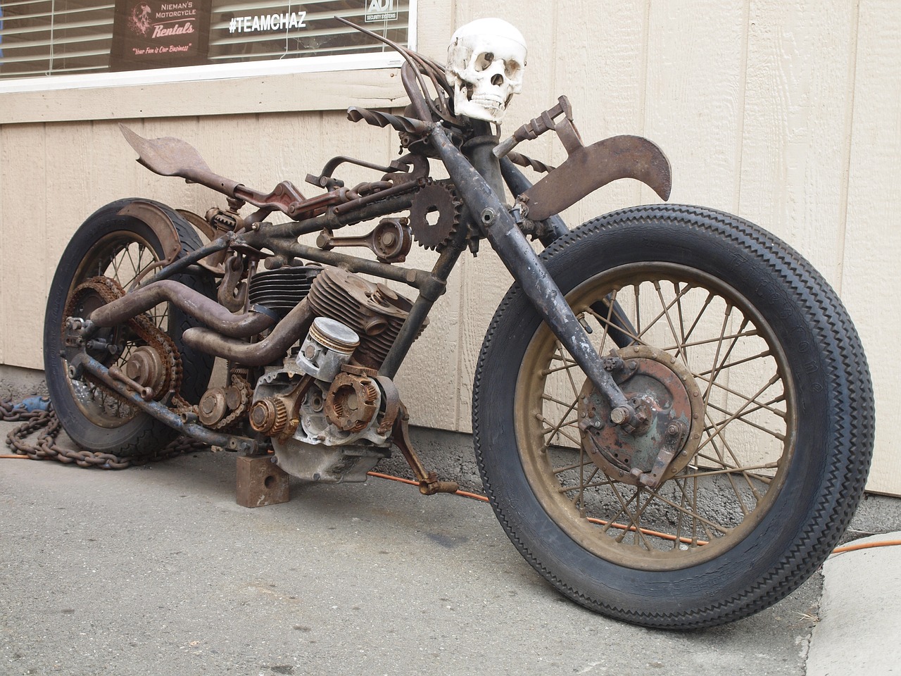 a close up of a motorcycle with a skull on it, flickr, dada, rusty components, junk on the ground, steam, bay area
