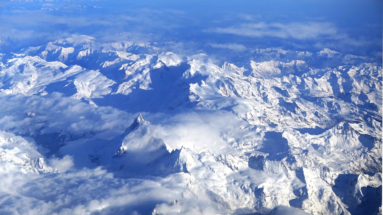 a view of snow covered mountains from an airplane, by Erwin Bowien, 7 7 7 7, detalied, teaser, thumbnail