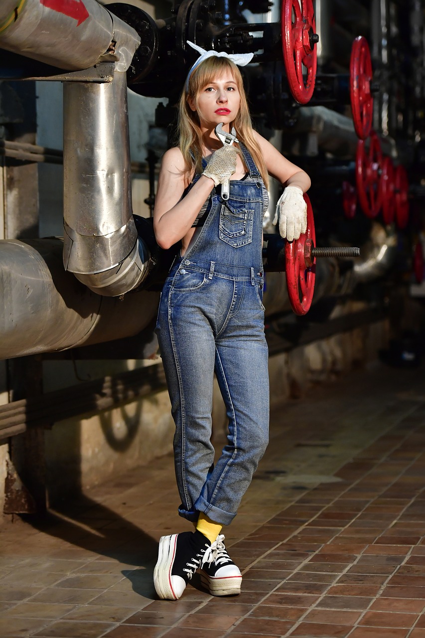 a woman in overalls posing for a picture, inspired by August Sander, bauhaus, anya_taylor-joy, uhd candid photo of dirty, minion, blue long pants and red shoes