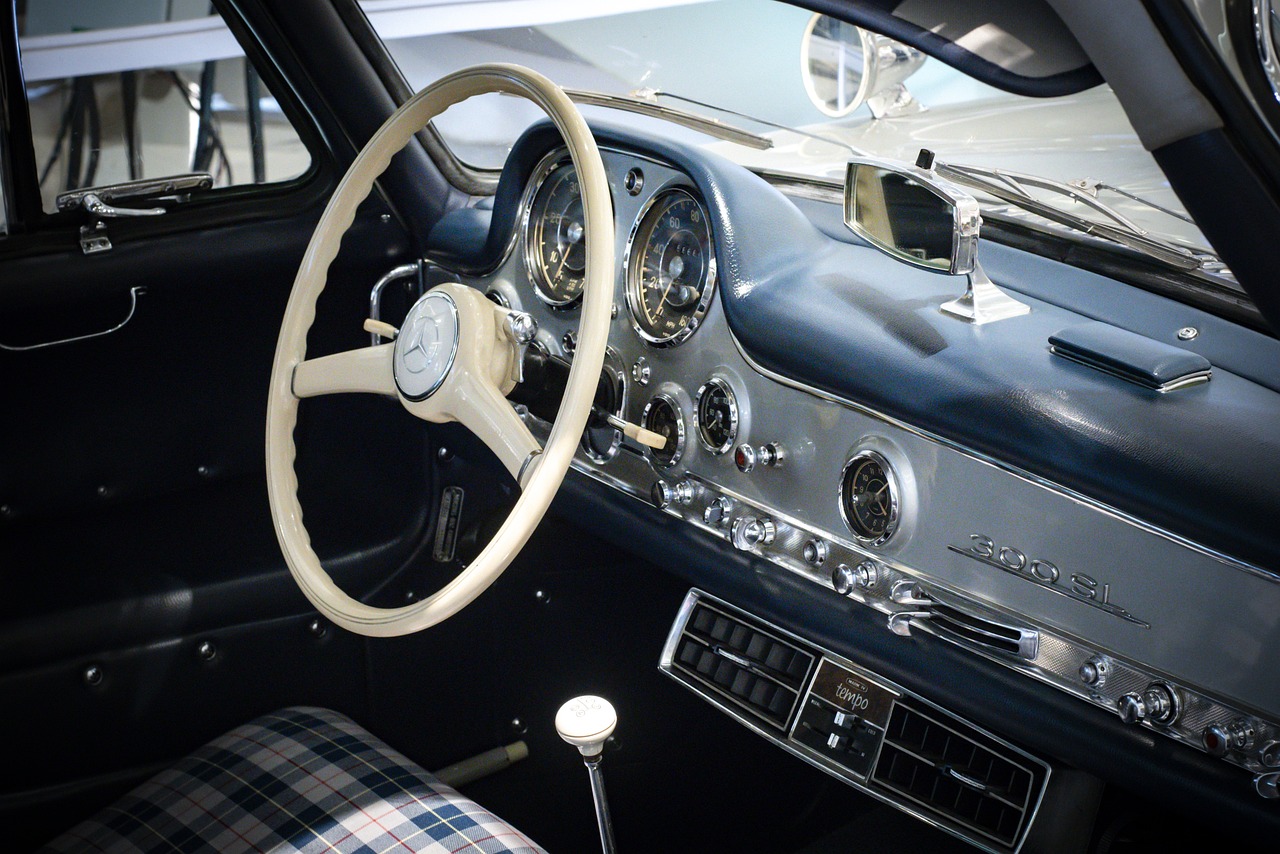 a close up of a steering wheel in a car, by Leo Goetz, retrofuturism, mercedes, porsche 356, on display in a museum, interior of a small