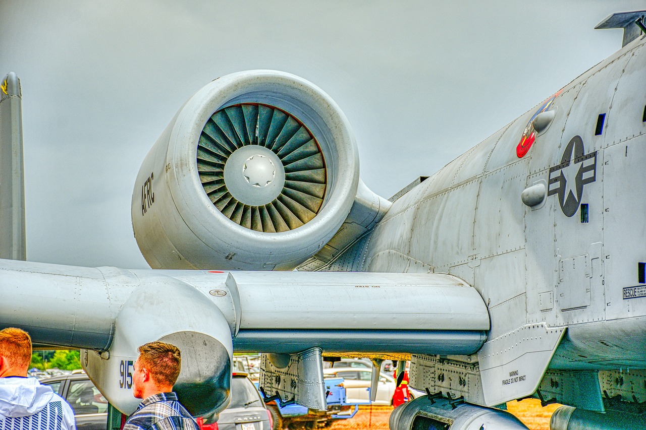 a group of people standing in front of an airplane, a stock photo, by Jan Rustem, precisionism, jet turbine, hdr detail, peering over from his heavy, military equipment