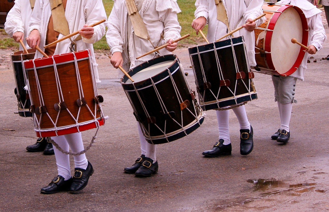 a group of men standing next to each other holding drums, by Robert Brackman, shutterstock, figuration libre, military parade, detailed shot legs-up, of a old 18th century, delightful surroundings