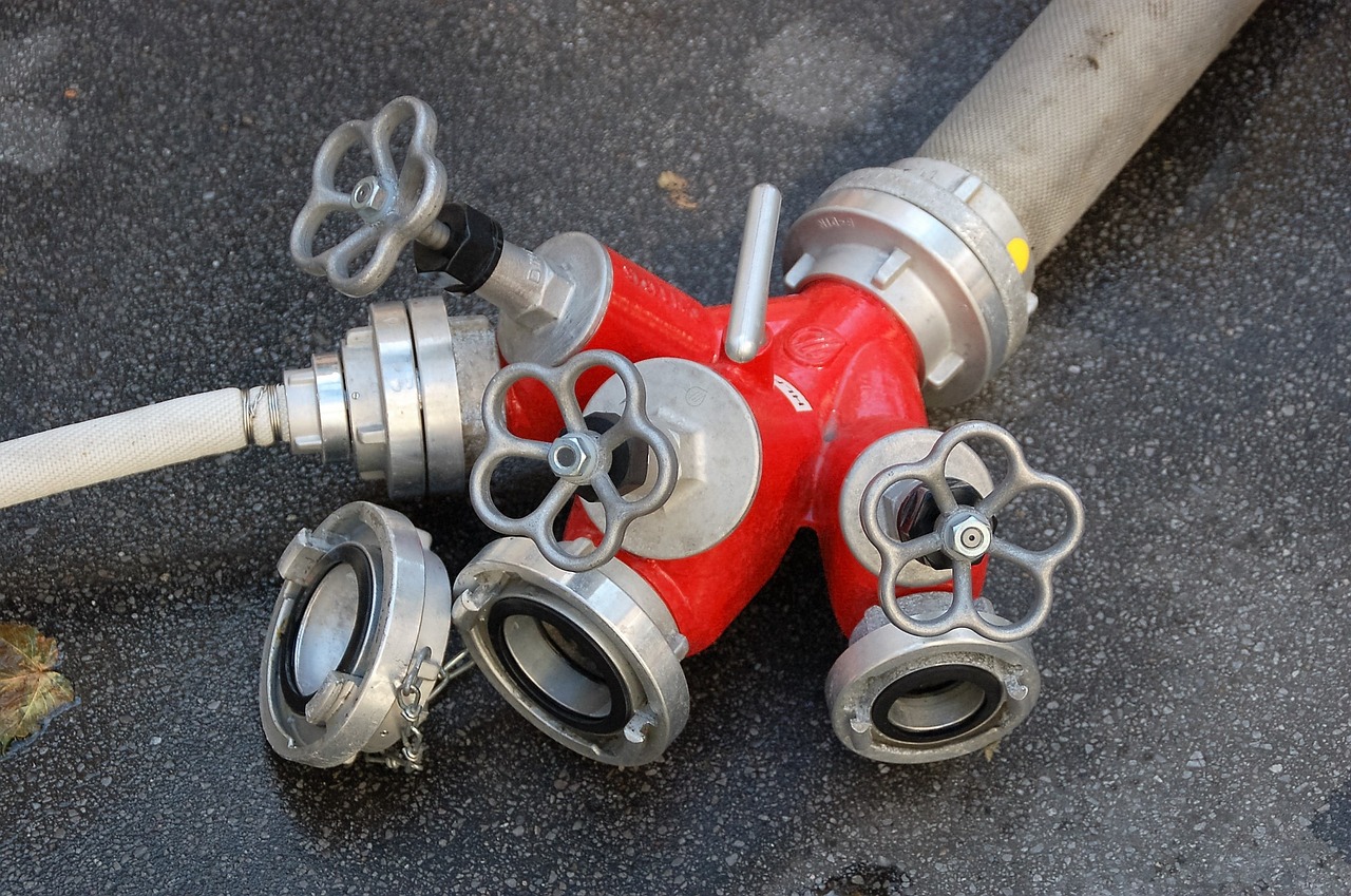 a close up of a fire hydrant on the ground, a photo, articulated joints, aluminum, puppies, hoses