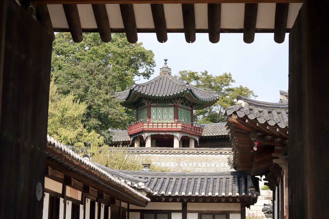 a view of a building through a doorway, inspired by Kim Hong-do, shutterstock, shin hanga, peaked wooden roofs, high - angle view, stock photo, pavilion