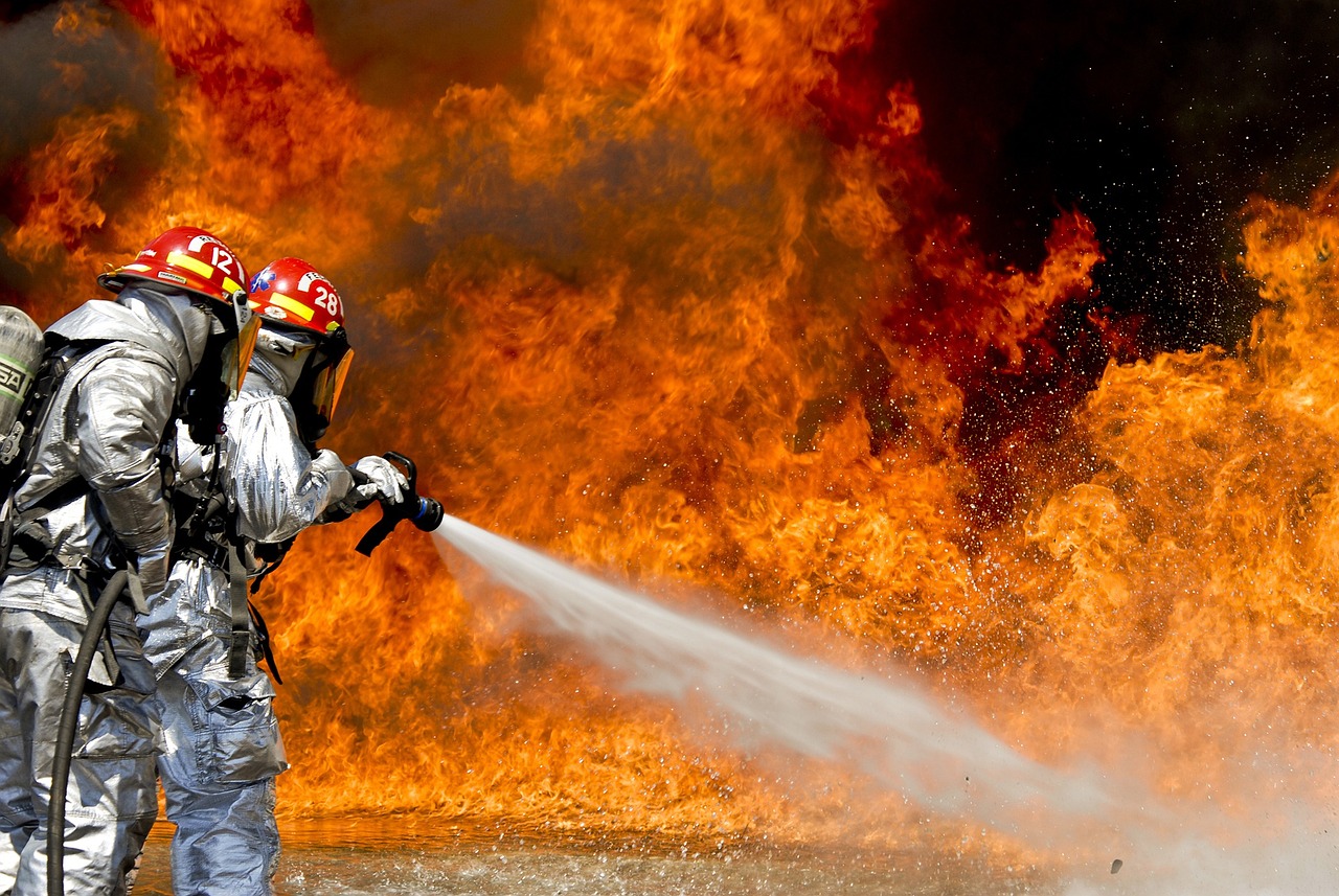 two firefighters are fighting a fire with a hose, a picture, shutterstock, fine art, wallpaper - 1 0 2 4, reuters, islamic, afp