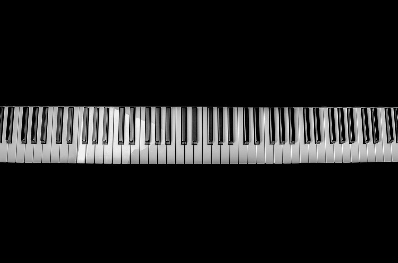 a close up of a piano keyboard on a black background, an ambient occlusion render, by Jan Kupecký, pixabay, minimalism, youtube video, [ overhead view ]!!, taken with a pentax k1000, hans zimmer soundtrack