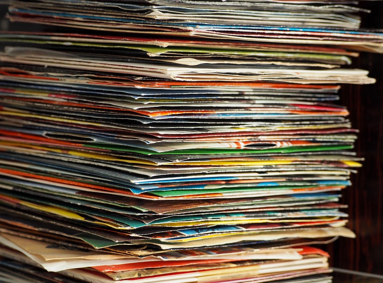 a stack of magazines sitting on top of a table, by Matija Jama, flickr, maximalism, vinyl records, close-up!!!!!, hq ”, stained”