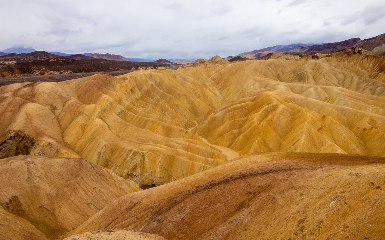 a view from the top of a mountain in death valley national park, death valley national park, death valley national park, death valley national park, by Etienne Delessert, shutterstock, color field, vibrant but dreary gold, strange formations