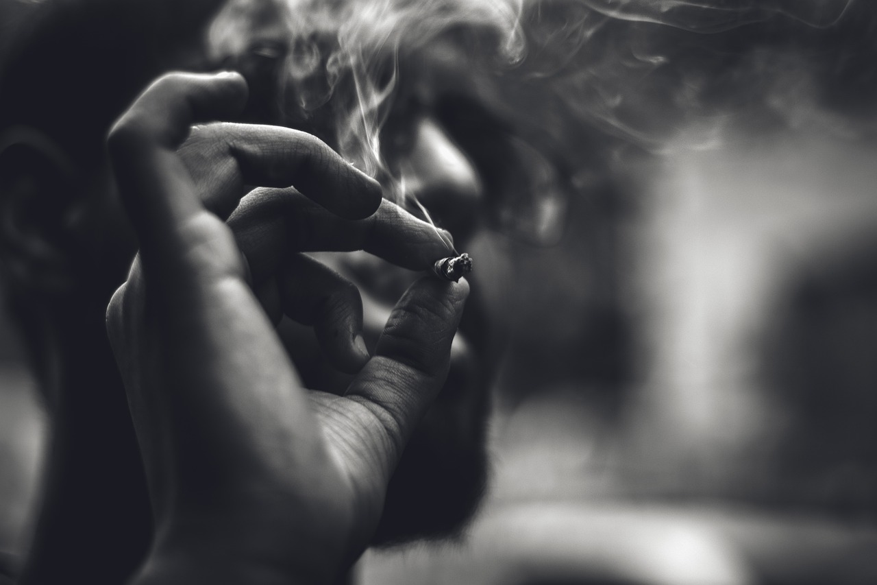 a close up of a person smoking a cigarette, a black and white photo, by Mirko Rački, shutterstock, harry potter smoking weed, fire in hand, monochromatic photo, high details photo