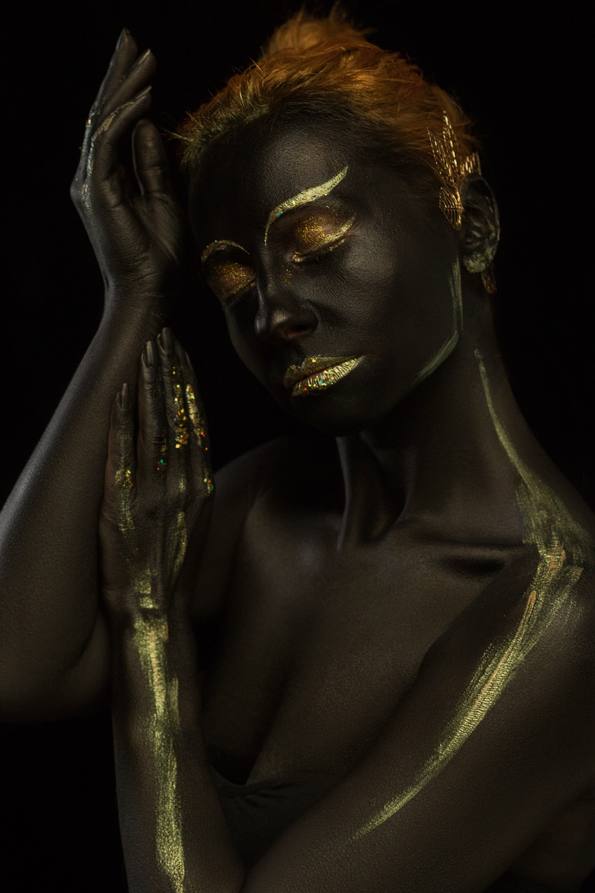 a close up of a person with gold paint on their face, a photorealistic painting, inspired by Hedi Xandt, afrofuturism, dark chocolate painting, shot at night with studio lights, photography alexey gurylev, full body painting